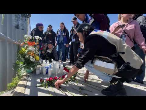 People lay flowers for migrants who died in Mexico detention centre fire