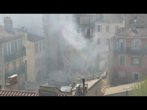 Excavator on site of Marseille building collapse as smoke rises