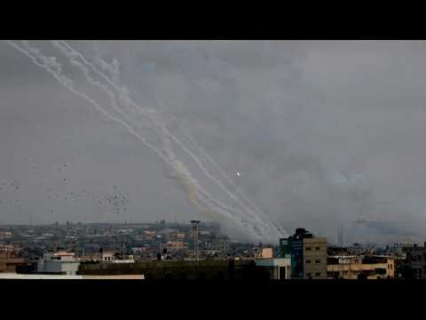 Smoke billows and barrage of rockets fired from Gaza towards Israel