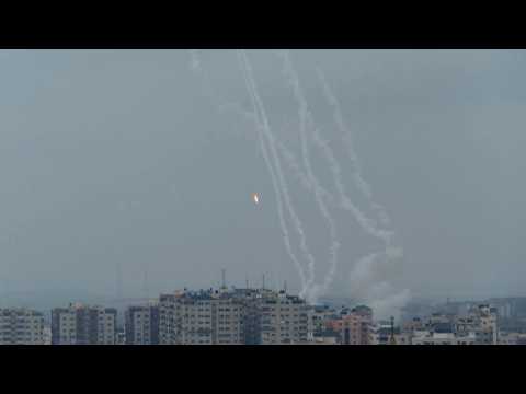 Smoke rises and rockets fired from Gaza Strip into Israel