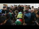 Palestinians mourn over body of 17-year-old during funeral procession