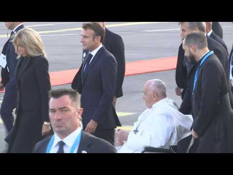 Pope Francis with Emmanuel and Brigitte Macron at the airport