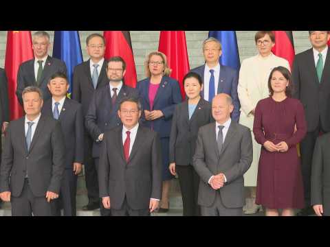German and Chinese officials pose for family photo in Berlin