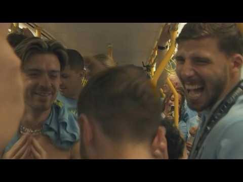 City players take tram through Manchester for treble celebrations