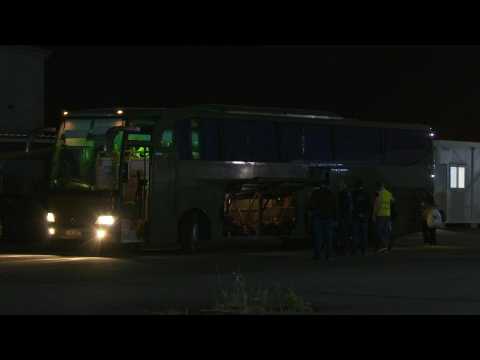 Evacuees from Sudan board a bus after British flight lands in Cyprus