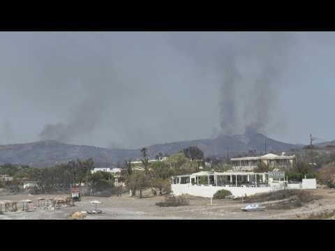 Smoke rises above evacuated Greek town of Kiotari on Rhodes as fires rage