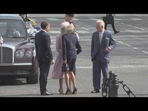 Brigitte Macron kisses Queen Camilla under the Arc de Triomphe