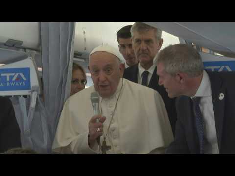 Pope Francis greets journalists on the plane before flying to Marseille