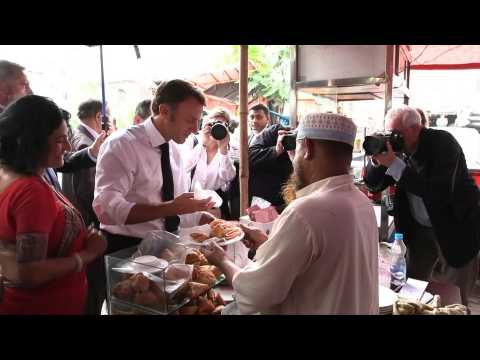 France's Macron samples local food in Bangladesh, takes boat trip