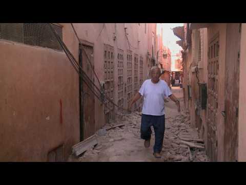 People walk amid rubble in the Jewish quarter of quake hit Marrakesh