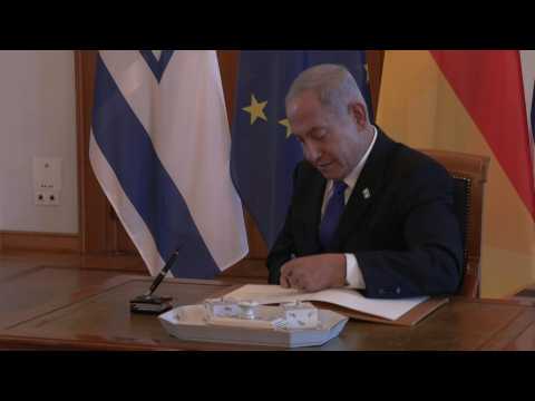 Images of Israel's Netanyahu signing the guestbook at Bellevue Palace with Steinmeier