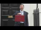 UK finance minister poses with traditional red box ahead of budget announcement