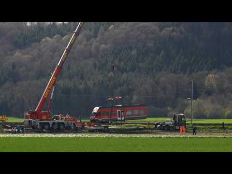 Cranes at work to clear derailed Swiss train near Bern
