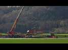 Cranes at work to clear derailed Swiss train near Bern