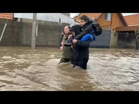 People evacuate flooded streets after heavy rains hit central Chile