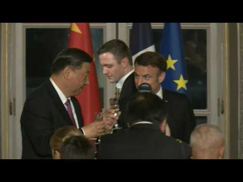 Macron and Xi toast at a state dinner at the Elysee Palace