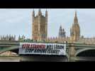Activists unfurl banner near UK parliament asking 'Will Labour stop arming Israel?'
