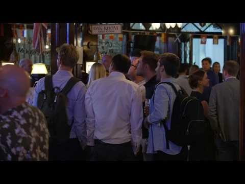 Londoners watch general election exit poll at the pub