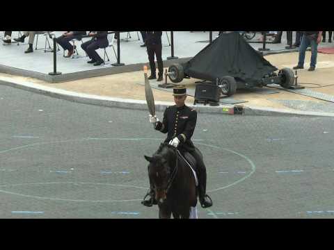 Olympic flame presented during Bastille Day parade in Paris