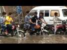 Traffic struggles through flooded road in Lahore, Pakistan after record rainfall