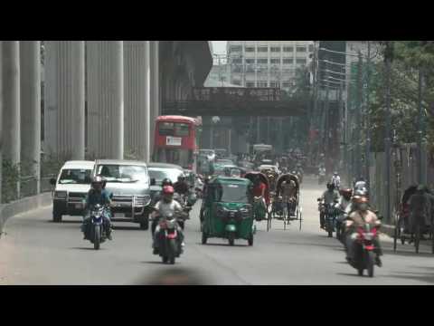 Traffic and pedestrians on Dhaka street after military takes control of Bangladesh