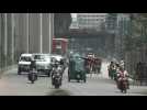 Traffic and pedestrians on Dhaka street after military takes control of Bangladesh