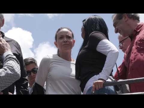 Venezuelan opposition leader Maria Corina Machado rides toward anti-Maduro election protest