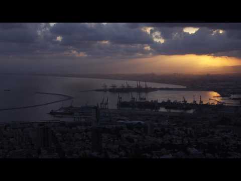 Sun rises over the Israeli city of Haifa and its port