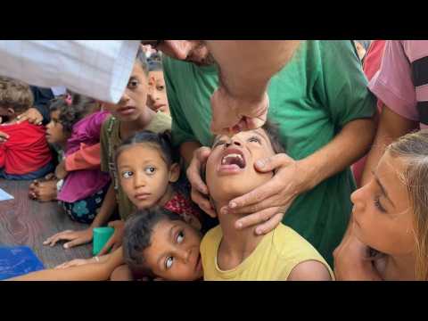 Healthcare workers administer polio vaccine drops to Gazan children