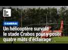 Un hélicoptère survole Cambrai pour poser quatre mâts d'éclairage au stade Crabos
